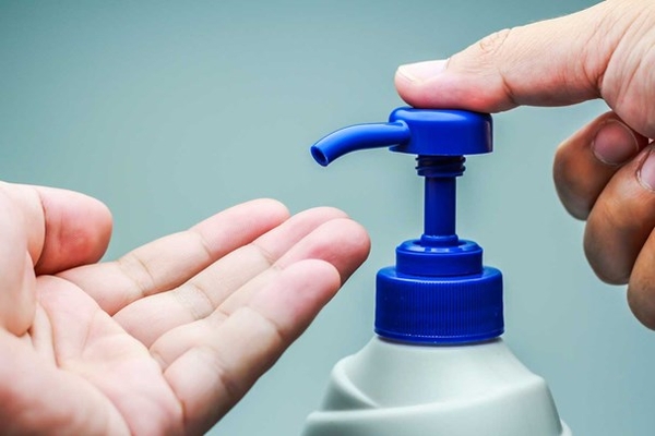 Download man-getting-moisturiser-out-of-bottle.jpg